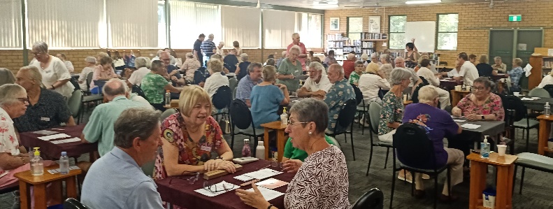 A group of people sitting at tables

AI-generated content may be incorrect.